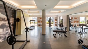 A modern gym with various exercise equipment, large windows, and a clean, well-lit interior. - DELPLAZA Marabá São Paulo (São Paulo)