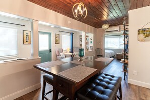 Enjoy a stylish space with a dining table, comfortable seating, and decorative accents.