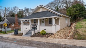 A single-story house with a front porch, a small front yard with a bush, and a mailbox. - Cheerful Pet-Friendly Bungalow 1 Block from Downtown Laurens (Laurens)