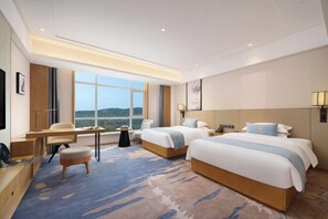 A hotel room with two beds, a desk, a chair, a small table, and a large window. - Haoweiyi International Hotel (Nanbu County)