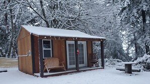 A wooden cabin with a porch, a bench, and a fire extinguisher. - Bunkhouse Dry Cabin Farm Rustic private secure (Lebanon)