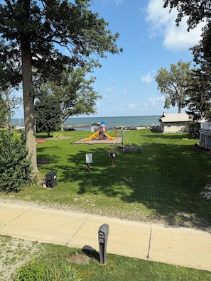 A park with a playground, a parking meter, and a view of the water. - Lakefront home. Beach & park access. 8 miles to Cedar Point. 4 bedrooms 3 baths. (Huron)