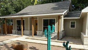 A house with a covered porch, a stone foundation, and a number '108' on the post. - Charming new home near Canyon Lake/Guadalupe River (Canyon Lake)