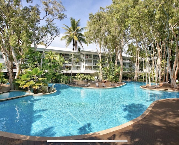 Relax by the pool surrounded by lush tropical vegetation and lounge in style.