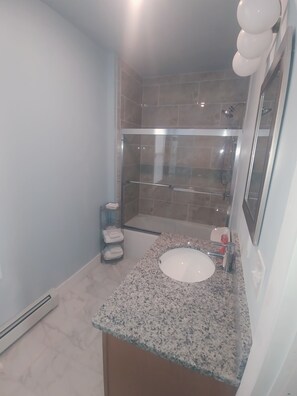 Combined shower/tub, hair dryer, towels, soap