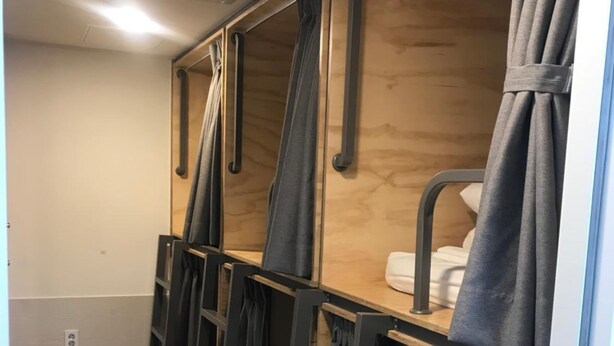 A compact, single-room layout with a bunk bed, a small bedside table, and a curtain. - Step Inn Myeongdong 2 (Seoul)