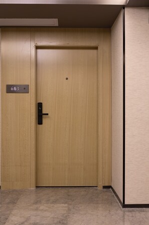 A wooden door with a number plate labeled "603" and a modern door handle. - Paco Hotel Jiangtai Lu Metro Guangzhou (Guangzhou)