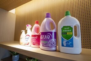A shelf with various cleaning products. - Zijin Hotel (Shanghang)
