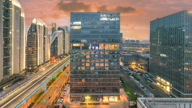 A modern hotel with a glass facade, multiple floors, and a prominent entrance. - Ji Hotel Nanjing South Railway Station Square (Nanjing)