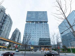 A modern high-rise hotel with a glass facade, multiple floors, and a prominent entrance. - Ji Hotel Nanjing South Railway Station Square (Nanjing)