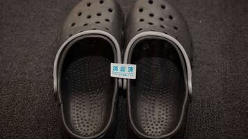 A pair of black shoes with a label that reads "消費済" (consumed).