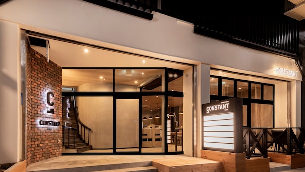 A modern hotel entrance with a brick facade, a staircase leading to the entrance, and a sign reading "Constantin". - CABIN&HOTEL CONSTANT NAHA (Naha)