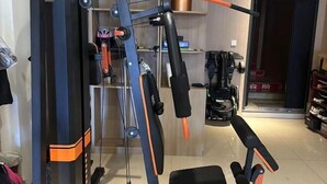 A gym with exercise equipment, including a pull-up bar and a bench. - Jin Hao Hotel (Dunhua)