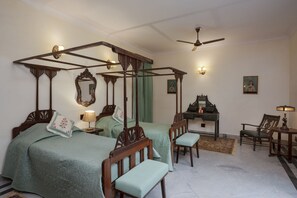 A traditional bedroom with four single beds, a desk, and a chair. - amã Stays & Trails Kothi Umednagar, Jodhpur (Tivari)