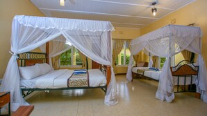A room with two beds, each with a canopy, a wooden bench, and a window with curtains. - Lomanira Splendour (Mogotio)