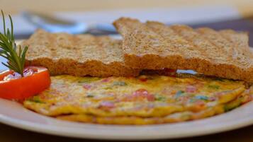 A plate with a slice of toast, a slice of bread, and a piece of toast on a table.