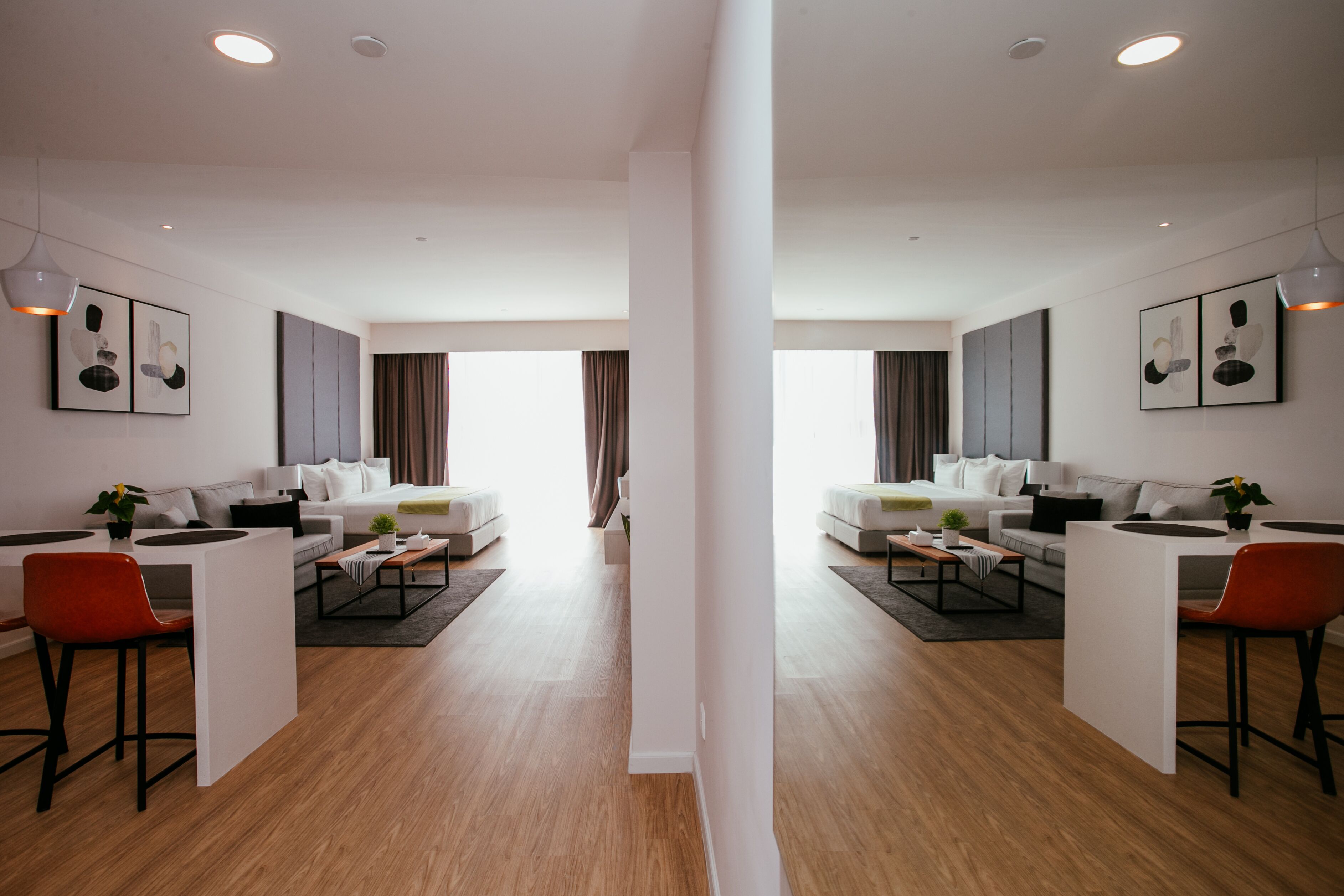 A modern living room with two sofas, a coffee table, and a dining area with a chair and table.