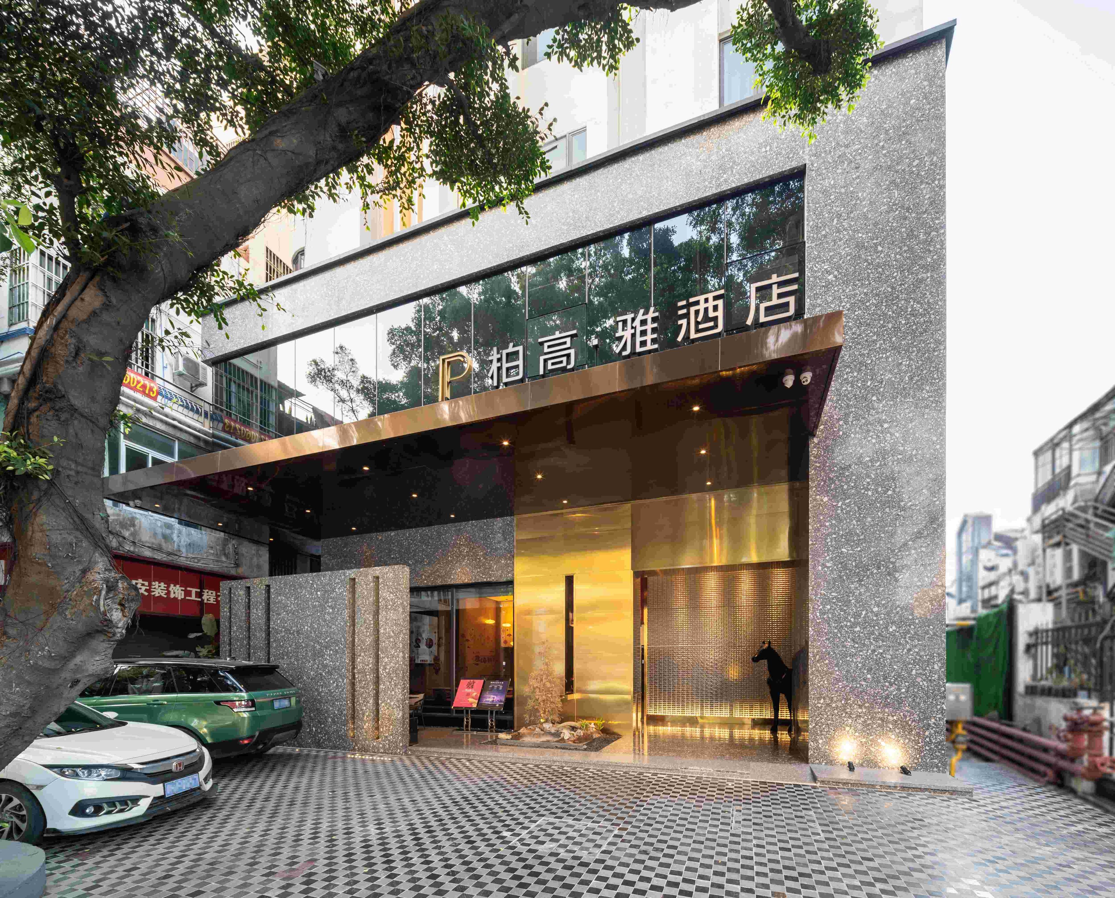 A modern building with a glass facade and a sign that reads "P. Absor High."