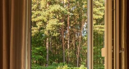 Apartment with a cozy terrace and a view of the pine trees