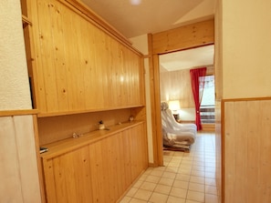 A wooden-paneled room with a bed, a chair, and a small table. - Renovated apartment for 4-6, near village in Morillon (Morillon Village)