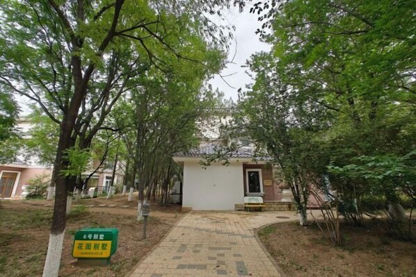 A pathway leading to a small building surrounded by trees. - RGHCM Garden Resorts (Beijing)