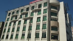 A multi-story building with a sign for 'Nomad Palace Hotel' at the top. - Nomad Paradise Hotel (Nairobi)