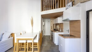 A modern kitchen with white cabinets, a wooden countertop, and a built-in oven. - L'Esprit Montpel "Face à l'Eglise St Roch" (Montpellier Spirit) (Montpellier)