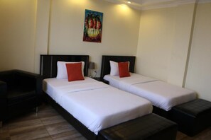 A hotel room with two single beds, a small sofa, and a bench. - Gigiri Express Hotel (Nairobi)