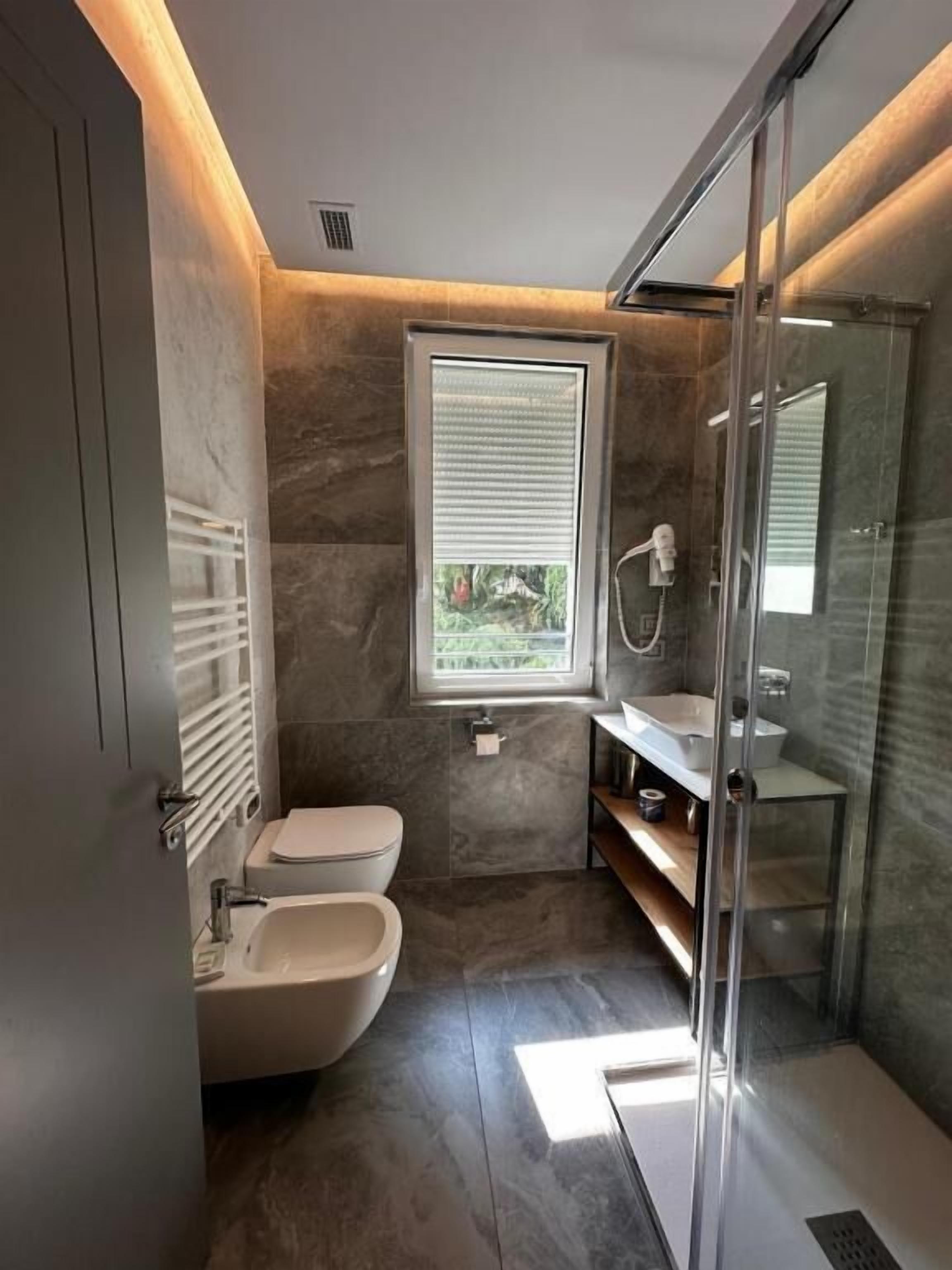 Habitación clásica doble | Baño | Ducha, secador de pelo, zapatillas y bidé