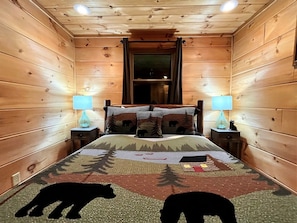 A cozy cabin room with a bed, two bedside tables, and a window. - Tree Top Getaway close to Fontana Lake and NOC - Free Train Tix! (Almond)