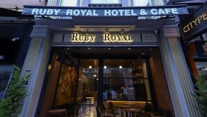 The exterior of the Ruby Royal Hotel & Cafe with a classic architectural design, featuring a prominent entrance and a signboard. - Ruby Royal Hotel (Istanbul)