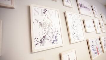 A wall with multiple framed artworks.