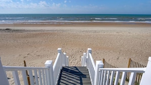 A wooden staircase leading to a beach with a view of the ocean. - Relax! Oceanfront Home | Pool | Hot Tub | Elevator (North Topsail Beach)