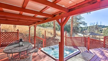 Relax on the deck with a hot tub and seating area.