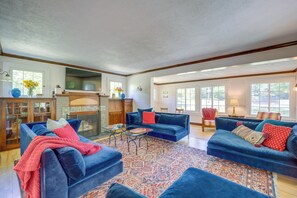 Relax in this inviting living room with a plush sofa, matching ottoman, and vibrant rug.