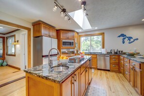 Enjoy cooking in this well-equipped kitchen with a refrigerator, microwave, and dishwasher.