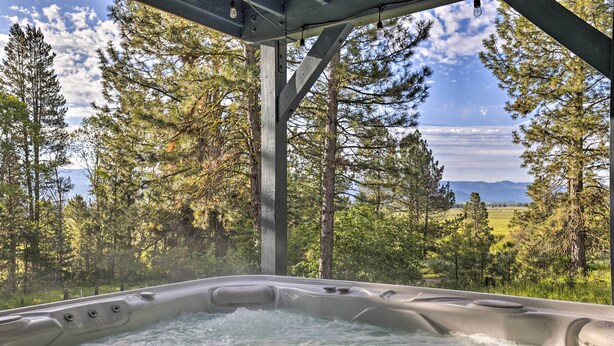 A hot tub with a view of a forest and mountains. - 'Peaceful Pines' - Cascade Cabin w/ Hot Tub! (Cascade)