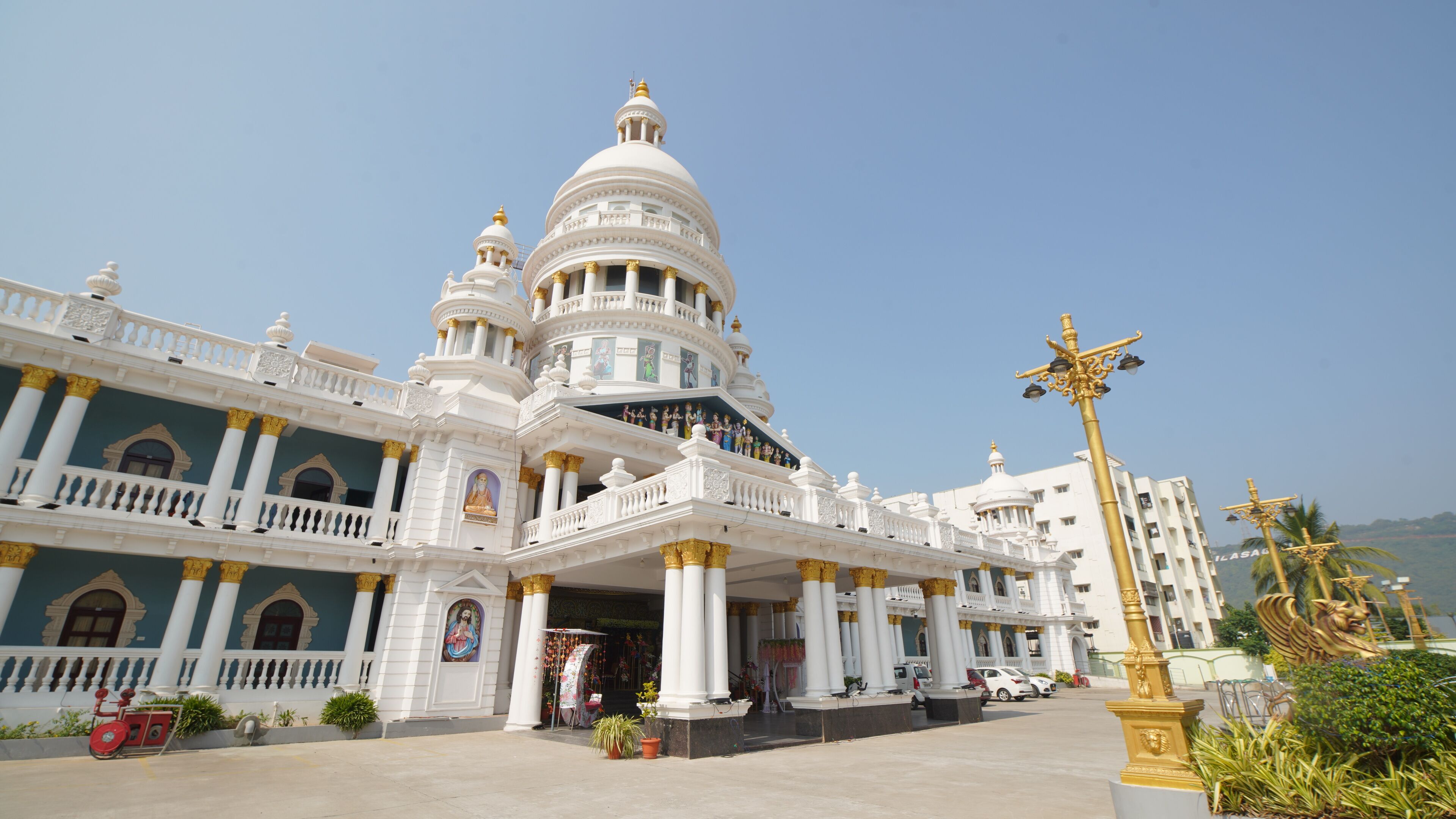 A large, ornate building with multiple domes and columns, likely a temple or cultural site.