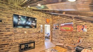 A rustic interior with wooden walls, a flat-screen TV, and a cozy seating area. - Hidden Lake Sanctuary  (West Union)
