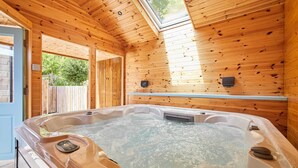 A wooden cabin with a hot tub, wooden walls, and a skylight. - Host & Stay | Littlebeck House (Whitby)