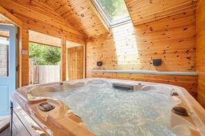 A wooden cabin with a hot tub, wooden walls, and a skylight. - Host & Stay | Littlebeck House (Whitby)