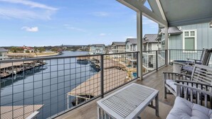 A balcony with a view of a marina and houses.