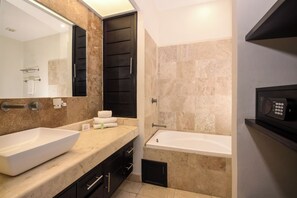 A modern bathroom with two large sinks, a bathtub, and a digital shower control panel.