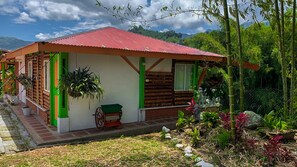 A rustic wooden house with a red roof, green accents, and a small cart outside. - LAKE VIEW CABIN (Pereira)