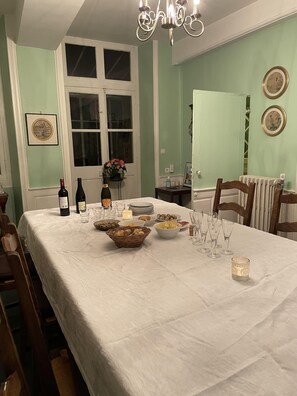 Enjoy a formal dining experience with a beautifully set table, complete with fine china and wine.