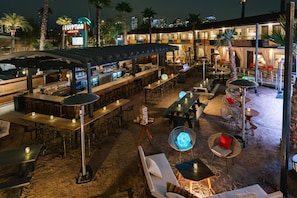 An outdoor bar area with tables, chairs, and a pool table. - Egyptian Motor Hotel, Bw Signature Collection (Phoenix)