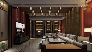 A modern living room with a sofa set, coffee table, and a television. - Mandao Hotel (Nanbu County)