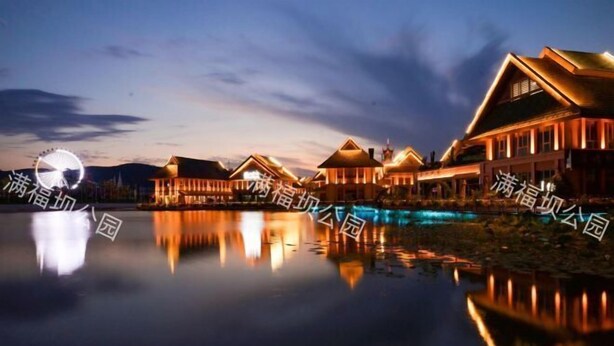 A waterfront hotel with multiple buildings, a calm lake reflecting the structures, and a clear sky. - Mandao Hotel (Nanbu County)