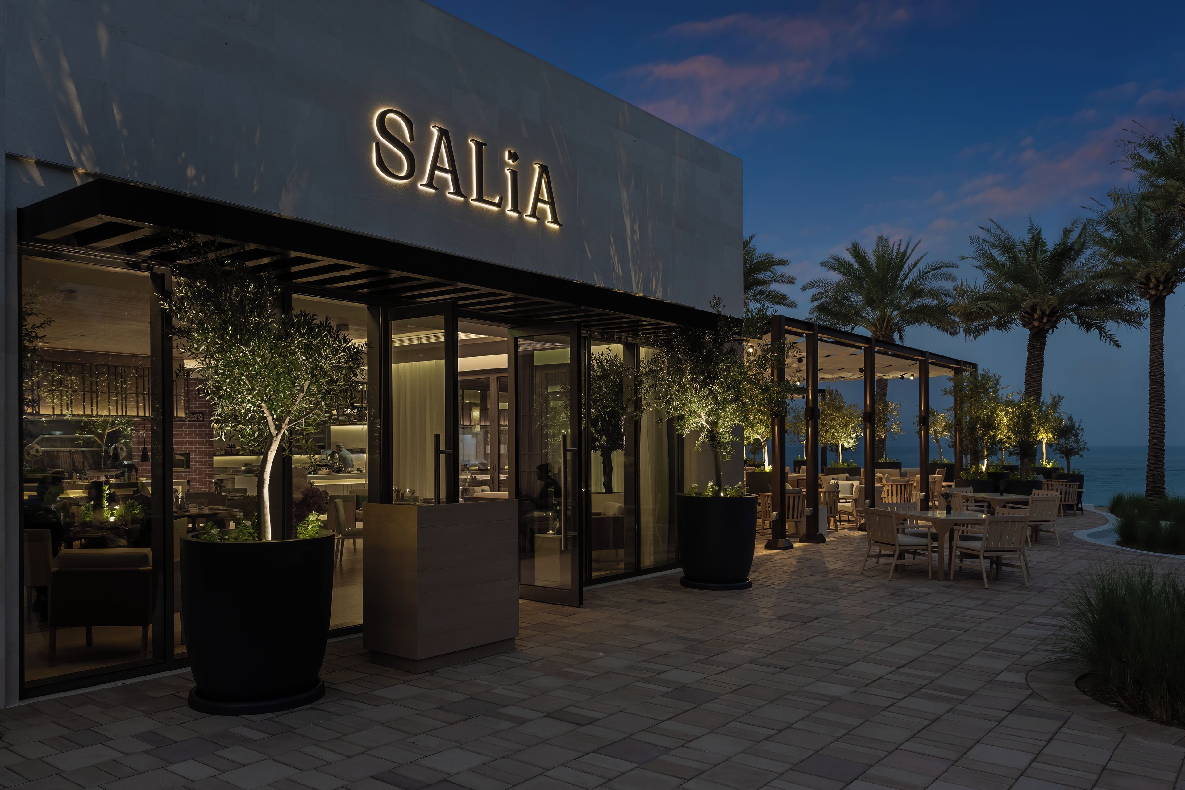 A modern building with the name "SALIA" illuminated on the facade.