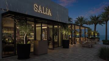 A modern building with the name "SALIA" illuminated on the facade.